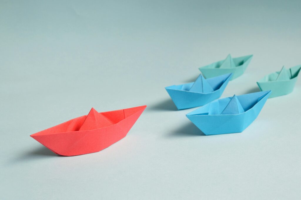 pexels-photo-194094-194094 Colorful origami paper boats arranged to depict leadership and teamwork concepts.